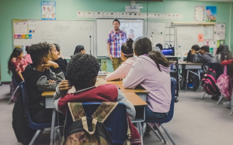 Children sitting at classroom desks with a teacher